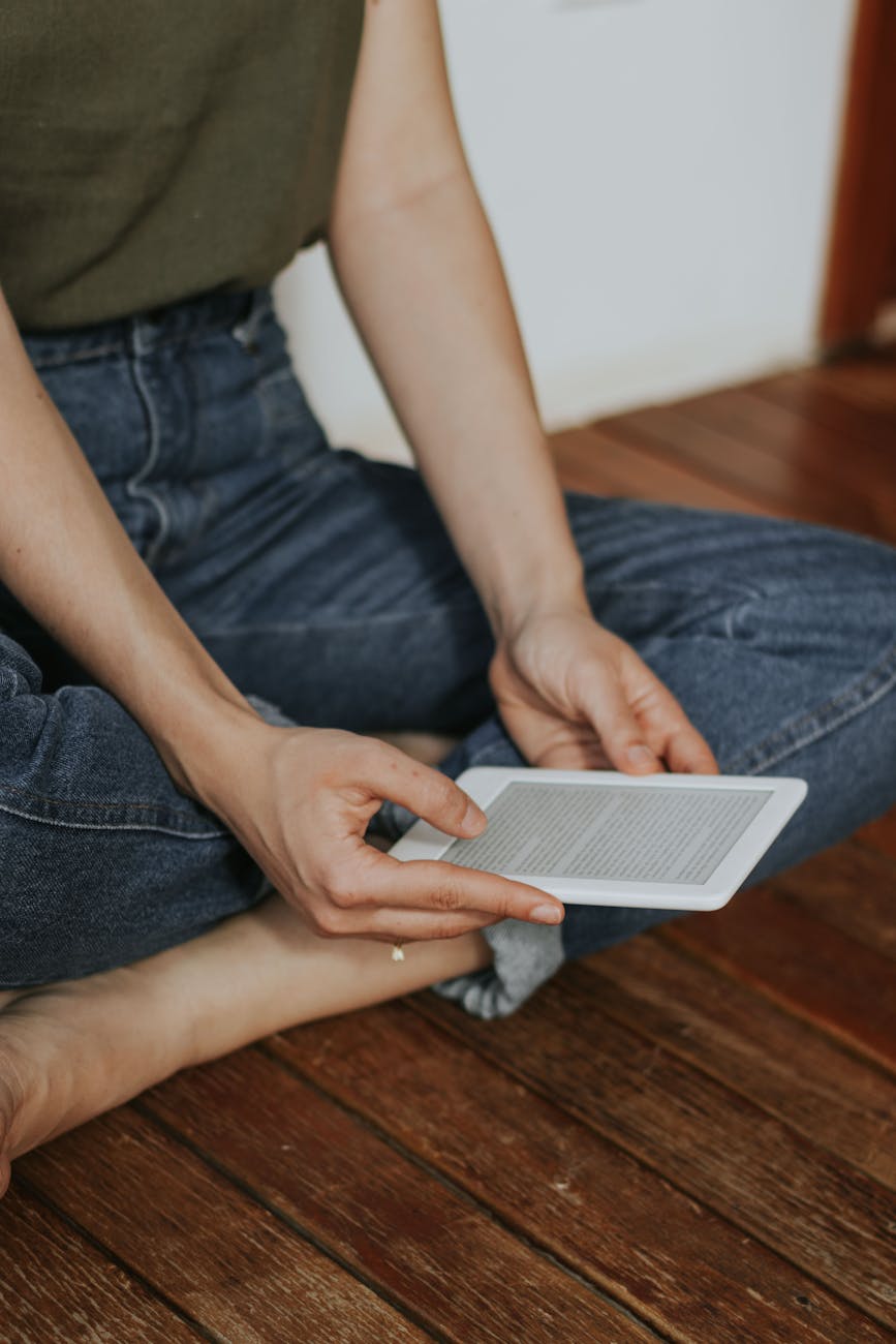 person reading on e reader while seated comfortably indoors